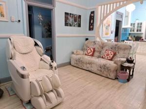 a living room with a chair and a couch at Rustic Sunflower in Mount Crosby