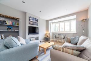 a living room with two couches and a tv at Garden Flat short walk to Kingston & Richmond Park in Strawberry Hill