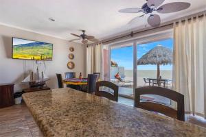 a living room with a table and a view of the ocean at Tai Condo 3 in Barra de Navidad