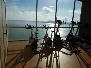 a group of exercise bikes in a room with the ocean at Ecuabook Riverfront Jacuzzi 11 Wyndham You home in Guayaquil