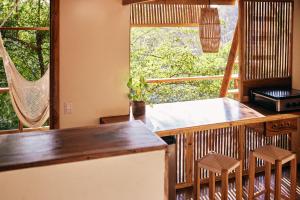 a kitchen with a balcony with a table and chairs at Hostel Clandestino Maderas in Playa Maderas