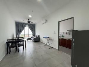 a kitchen and living room with a table and a dining room at Happy House in Sandakan