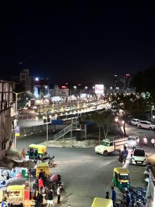 a busy city street at night with cars and people at HOTEL THE PACIFIC in Ahmedabad
