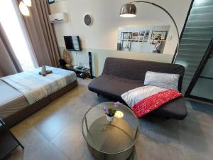 a living room with a couch and a glass table at Inspired Homes, Empire Duplex#1 in Petaling Jaya