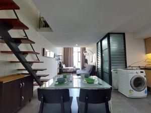 a kitchen with a table and chairs and a microwave at Inspired Homes, Empire Duplex#1 in Petaling Jaya