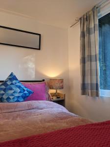 a bedroom with a bed and a window at Small 1-Bed Apartment in London in Croydon