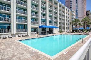 a large swimming pool in front of a building at Ocean Blvd Resort, Unit #1234 in Myrtle Beach