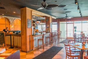 a restaurant with a bar with chairs and tables at Ocean Blvd Resort, Unit #1234 in Myrtle Beach