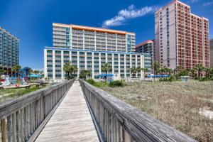 a wooden boardwalk over the beach with buildings at Ocean Blvd Resort, Unit #1234 in Myrtle Beach