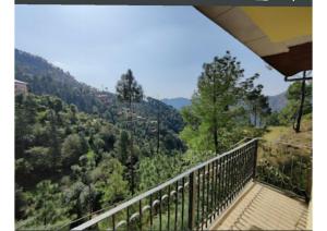 a balcony with a view of a mountain at Hotel Gopi Dham Ashram Haridwar Near Vrindavan in Haridwār