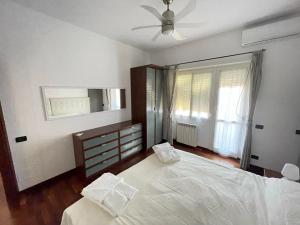 ein Schlafzimmer mit einem großen Bett und einem Deckenventilator in der Unterkunft Le Palme in Lido di Ostia