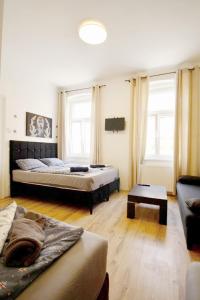 a living room with two beds and a couch at Family Apartment MZ27 in Vienna