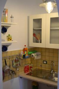 a kitchen with a sink and a counter top at Casa Colorata in Palermo