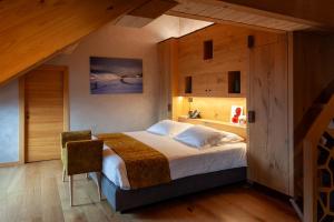 a bedroom with a large bed with wooden walls at Asiago Sporting Hotel & SPA - Buongiorno! Hotels in Asiago