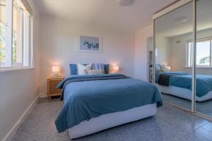 a bedroom with two beds and a large mirror at Stunning Apartment In South Perth in Perth