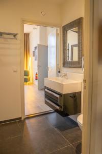 a bathroom with a sink and a mirror at Smartflats - L'Orangerie I Maastricht in Maastricht