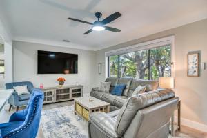 a living room with a couch and a tv at Serene St Petersburg Home with Private Hot Tub in St Petersburg