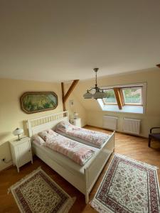 a bedroom with a bed and two rugs at Chalupa u Veseckých in Benešov