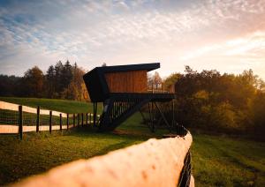 a smallshed in a field next to a fence at Treedom in Prievidza