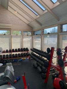 a gym with rows of dumbbells in a room at The Northport Inn Boutique Hotel R202 in Northport