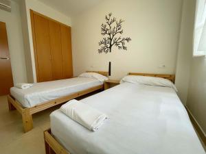 Postel nebo postele na pokoji v ubytování Apartamentos Los Almendros 3000