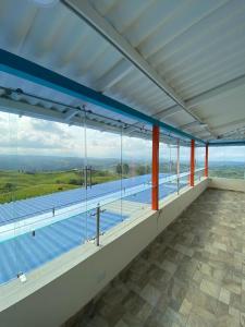 a large room with a view of a swimming pool at Villa Jair Hotel in Filandia