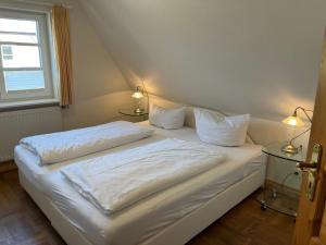 Ein Bett oder Betten in einem Zimmer der Unterkunft Haus am Südende Nordsee