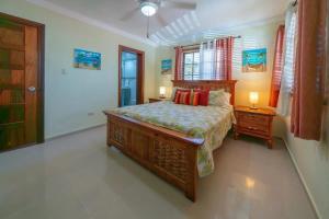 a bedroom with a large bed and a window at Welcome to Ville de Companeros in Punta Cana
