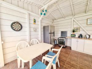 a kitchen and dining room with a table and chairs at Casa Cochilia - Camera Privata in Localitatea Tuzla in Tuzla