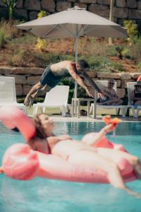 two people in a swimming pool with inflatables at Hacienda el Sueno in Fuengirola