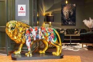 a statue of a lion in a living room at Amedia Hotel & Suites Leipzig, Trademark Collection by Wyndham in Leipzig