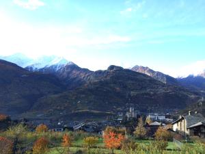 a town in front of a mountain range at Agriturismo Verger Plein Soleil in Saint-Pierre