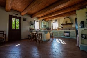 a kitchen with a counter and chairs in a room at B&B La Casa del Gallese in Sorbolongo