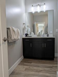 a bathroom with a sink and a large mirror at Downtown Traverse City Condo - Capri 209 in Traverse City