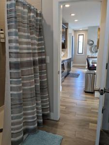 a living room with a sliding door with a curtain at Spacious Condo Downtown Traverse City in Traverse City