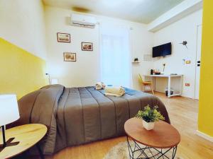 um quarto com uma cama, 2 mesas e uma secretária em Alilè em Sassari