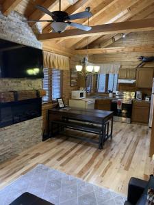 a living room with a table and a ceiling fan at Crystal Mountain Cabin Get Away in Thompsonville