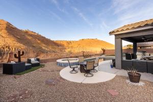 a patio with a table and chairs and a pool at Heated Pool at Double Eagle BL991277 by J and Amy in Mesquite