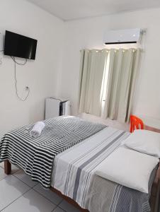 Uma cama ou camas num quarto em Hotel Monte Arau