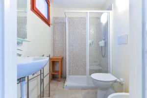 a bathroom with a shower and a toilet and a sink at Villa Le Terrazze in Capo D'Arco