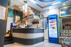 a restaurant with a counter and a drink refrigerator at CÁT PHÚC HOTEL in Ho Chi Minh City