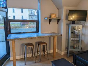 a bar with stools in a room with a window at Condo at The Commons in Traverse City