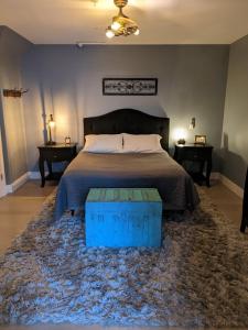 a bedroom with a large bed with a blue rug at Grand Traverse Commons Condo in Traverse City