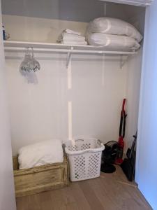 a walk in closet with a basket and some items at Condo at The Commons in Traverse City +40 photos