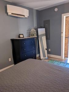 a bedroom with a bed and a blue dresser at Grand Traverse Commons Condo in Traverse City
