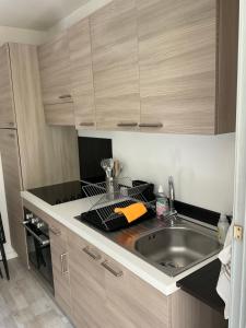 a kitchen with a sink and a counter top at Studio coin nuit terrasse parking Clim in Nice