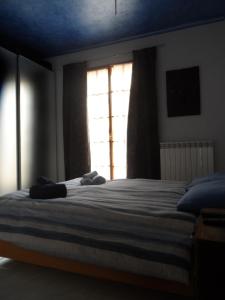 a bedroom with a large bed with a window at Maison Mare & Monti in Pesaro