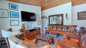 Villa Marfelia Spa في ريكورت: غرفة معيشة مليئة بالأثاث وتلفزيون بشاشة مسطحة