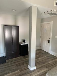 an empty room with a bed and a closet at Boutique Hotel Room 8 in Northport