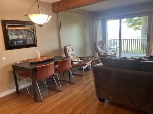 a living room with a couch and a table and chairs at 2 Bedroom Cozy Shanty Creek Condo in Bellaire